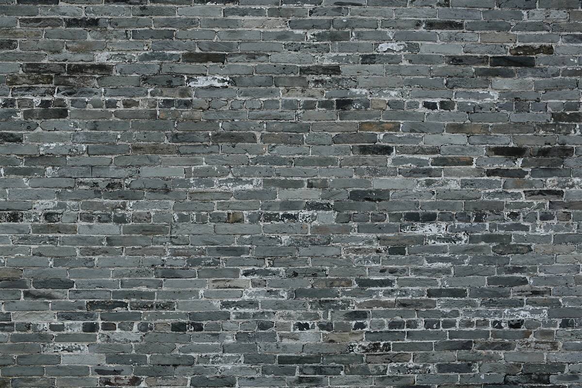 Carta da parati La parete in mattoni ha una tonalità grigio scuro.